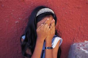 Girl hands over face