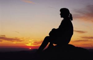 Woman silhouetted in sunset