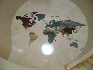 Inlaid marble floor at the foot of a circular staircase at the MIM